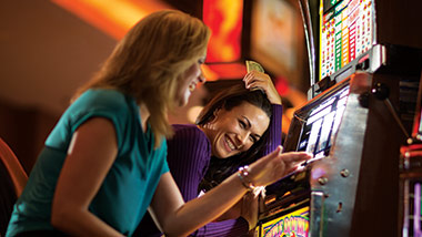 two women at slot machine